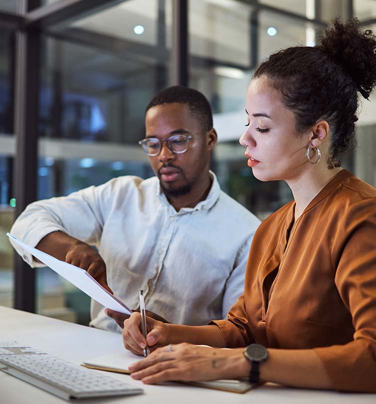 Professionals discussing telecommunications expense consulting services in a modern office setting.