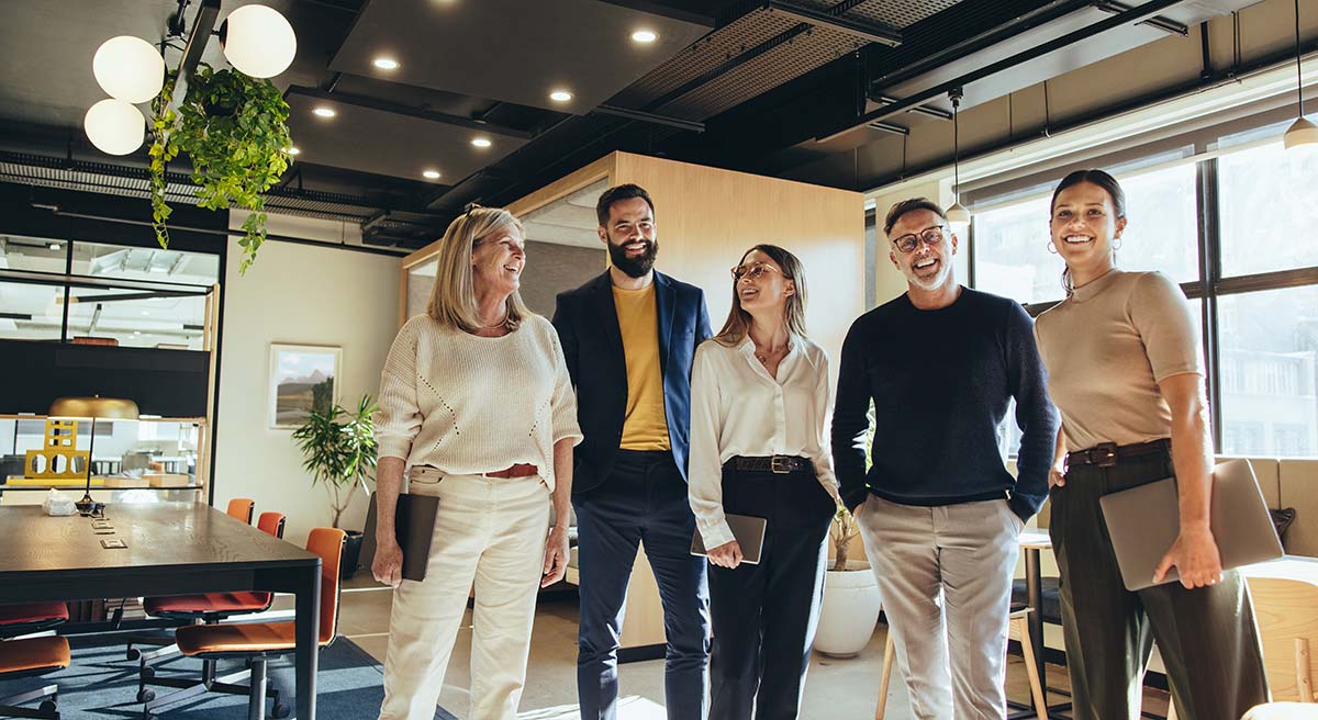 a group of business people in their office representing how telecom expense management for small businesses can reduce costs, optimize resources, and boost efficiency.